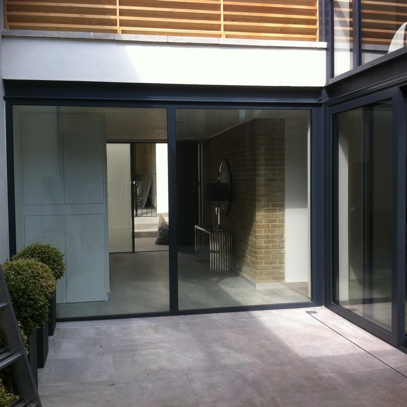 Floor-to-ceiling sliding doors opening to courtyard in Brixton