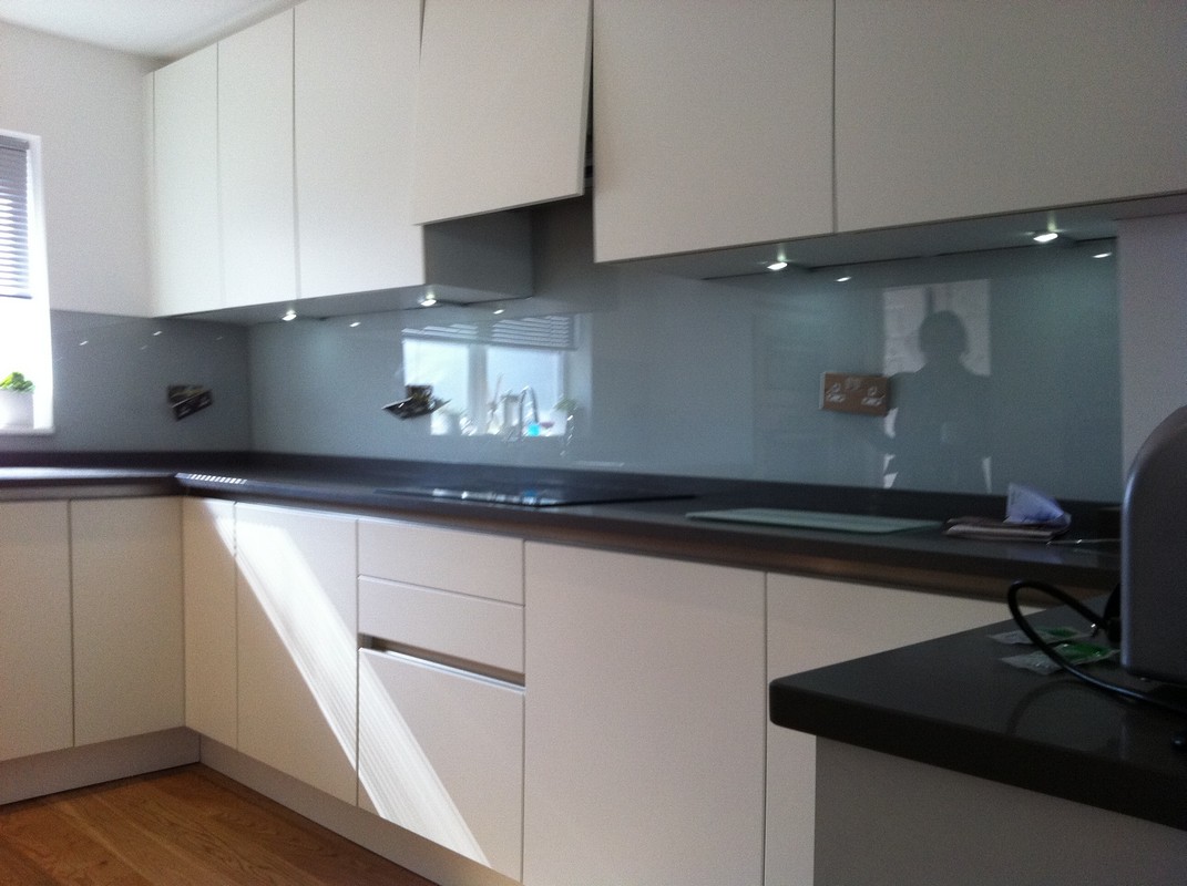 Grey glass kitchen splashback with LED lighting in Brixton